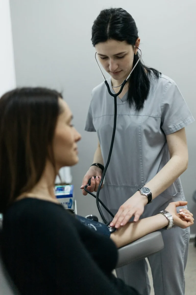 Лікарка вислуховує серце пацієнтки стетоскопом, медична мережа ЕКСПЕРТ